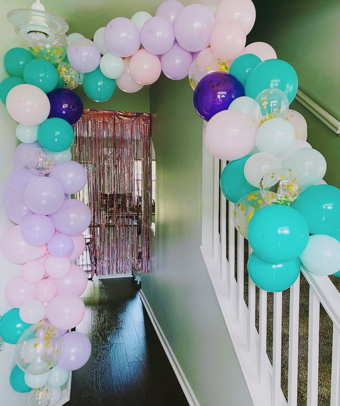 Pink, purple, and blue balloon garland decor.