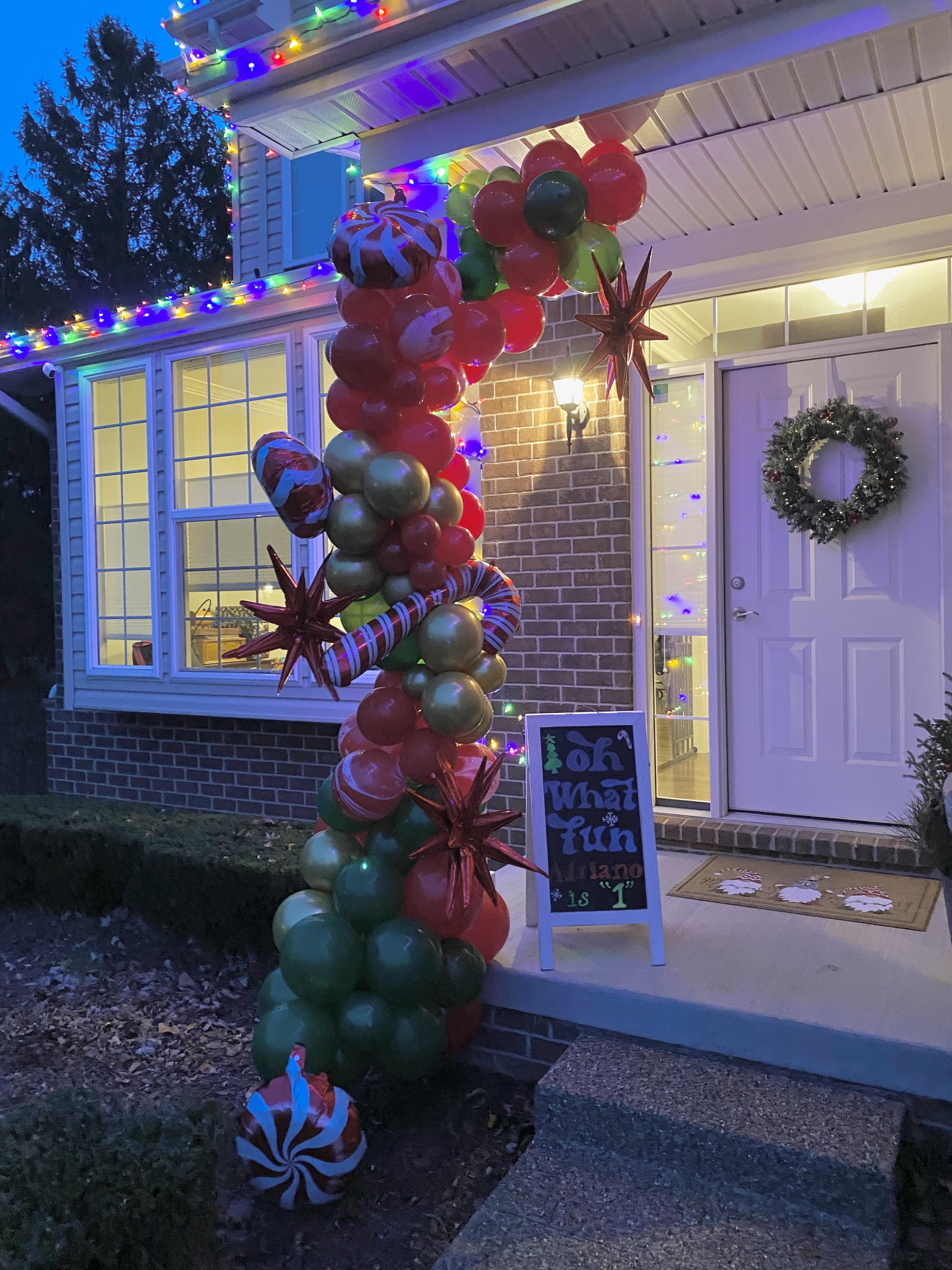 Christmas themed balloon garland arch outdoor decor.